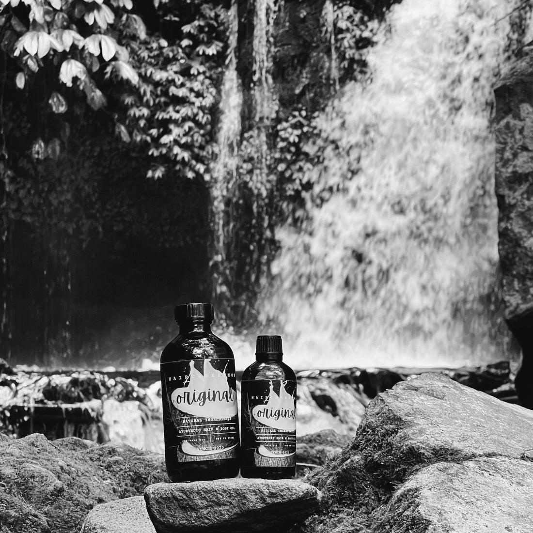 Original Ayurvedic Hair &amp; Body Oil 100ml and 250ml bottles in Bali, by the waterfall